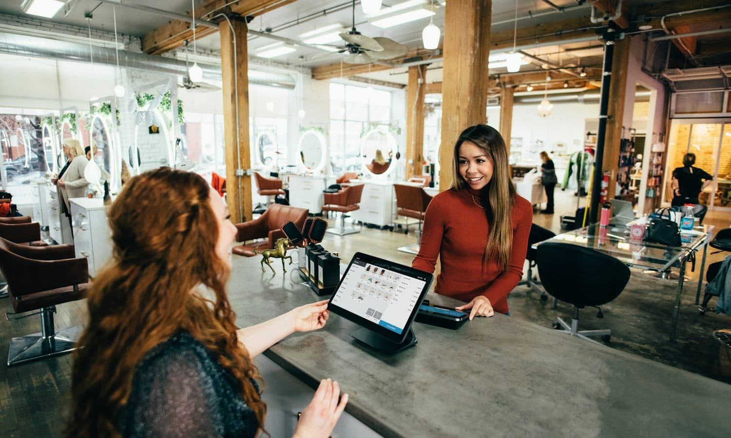 Customer paying at the counter of an independent retail boutique